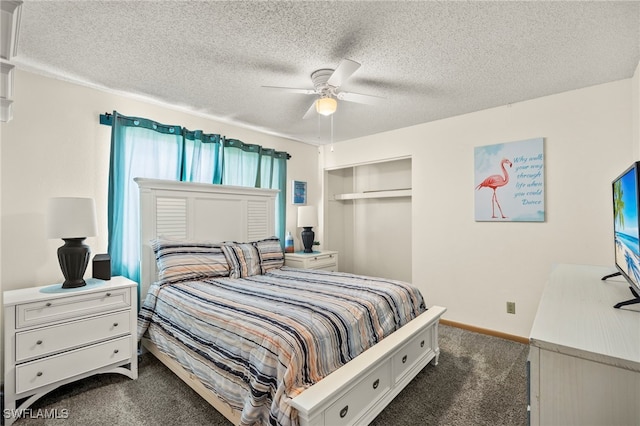 bedroom featuring dark colored carpet, ceiling fan, a textured ceiling, and a closet