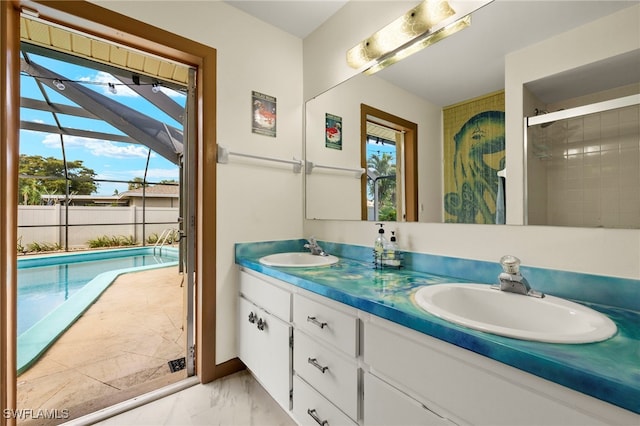 bathroom with a tile shower and vanity