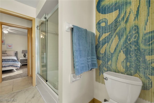 bathroom featuring ceiling fan, toilet, and combined bath / shower with glass door