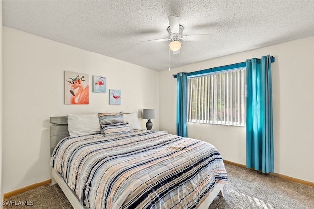 carpeted bedroom featuring ceiling fan and a textured ceiling