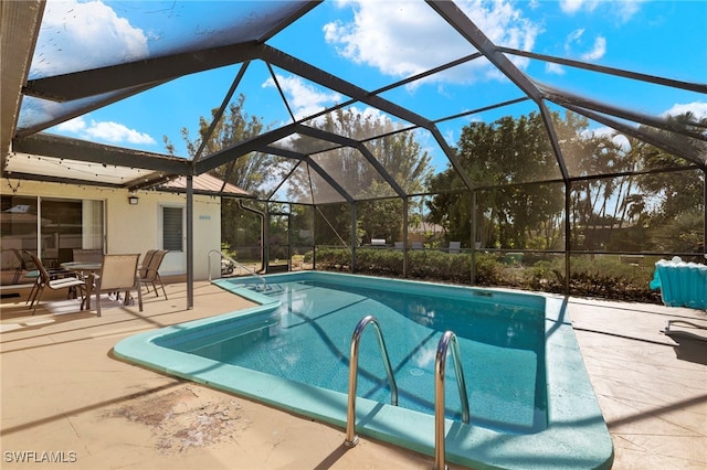 view of swimming pool featuring a lanai and a patio