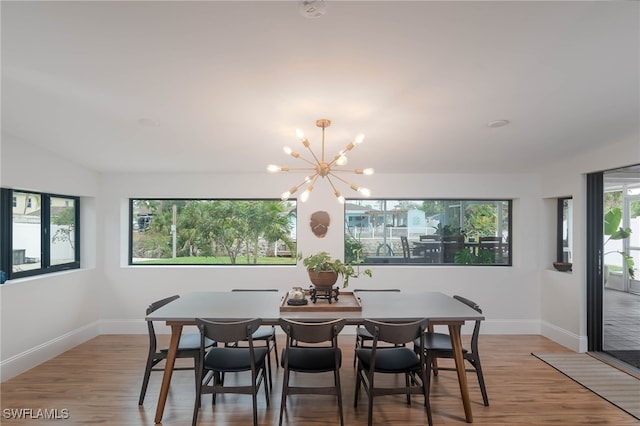 dining area with a chandelier and wood-type flooring