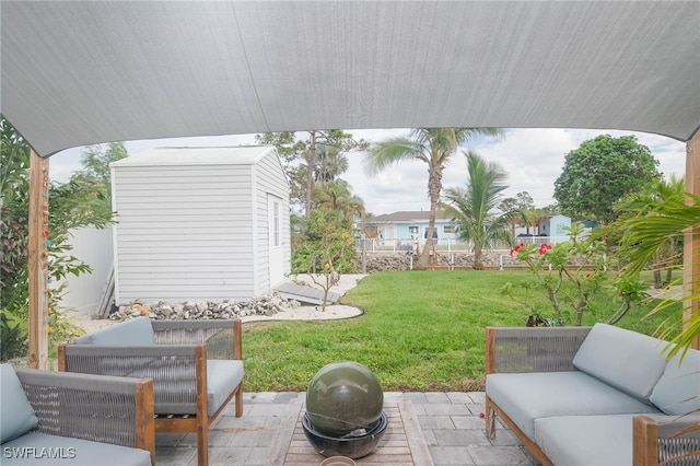 view of patio with an outdoor living space and a shed