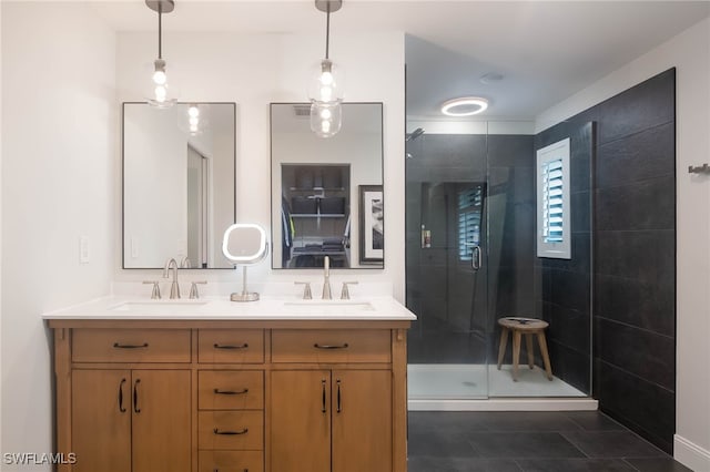 bathroom with tile patterned floors, vanity, and an enclosed shower