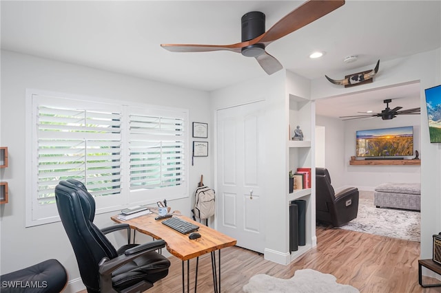 office with light wood-type flooring