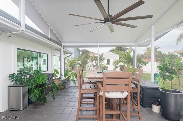 sunroom with plenty of natural light, ceiling fan, and vaulted ceiling