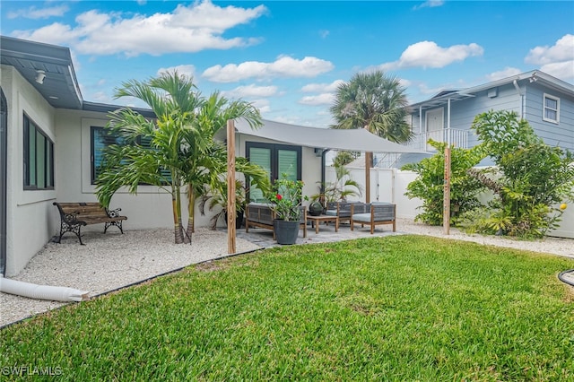 back of house with an outdoor living space, a yard, a patio, and french doors