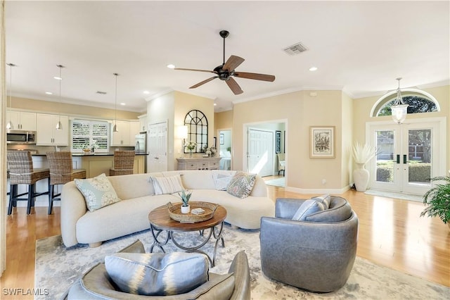 living room featuring a ceiling fan, visible vents, recessed lighting, french doors, and light wood finished floors