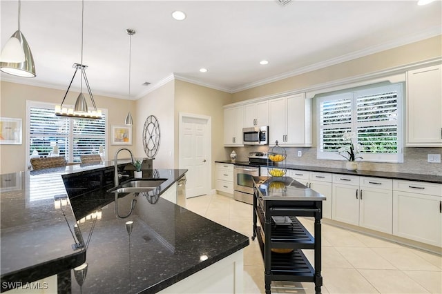 kitchen with a sink, a healthy amount of sunlight, tasteful backsplash, and stainless steel appliances