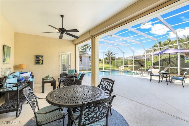 view of patio / terrace featuring a lanai, an outdoor hangout area, an outdoor pool, and a ceiling fan