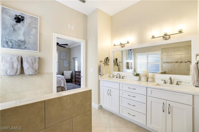 bathroom with tile patterned flooring, ceiling fan, and vanity