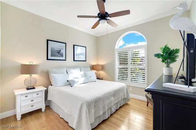 bedroom featuring ceiling fan, light hardwood / wood-style floors, and ornamental molding