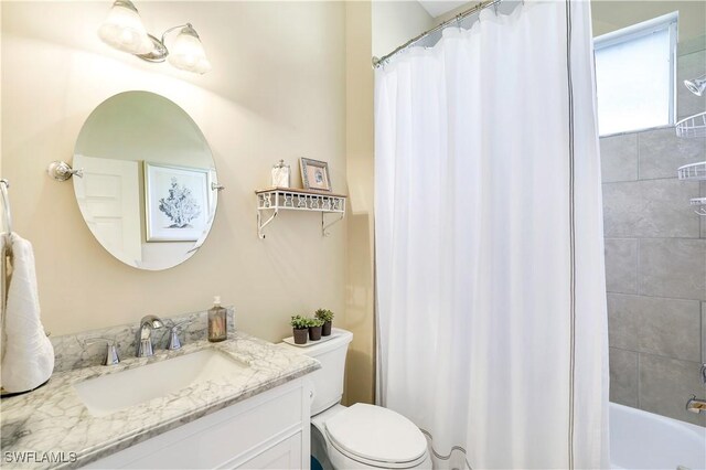 full bathroom with vanity, shower / bath combination with curtain, and toilet