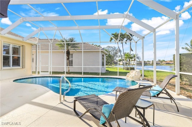 view of pool with pool water feature, a water view, a patio area, and a lanai