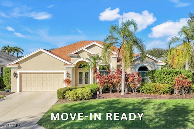 mediterranean / spanish home with an attached garage, driveway, and stucco siding