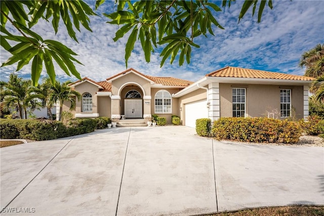 mediterranean / spanish home with a garage