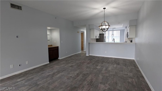 interior space featuring dark hardwood / wood-style flooring and an inviting chandelier