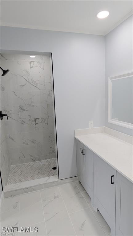 bathroom with vanity and a tile shower