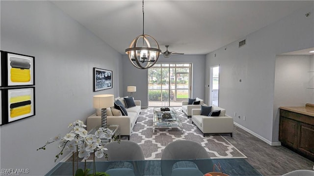 living room with hardwood / wood-style floors and ceiling fan with notable chandelier