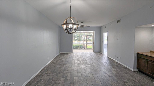 unfurnished dining area with dark hardwood / wood-style floors and ceiling fan with notable chandelier