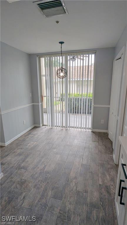 unfurnished dining area with dark hardwood / wood-style floors