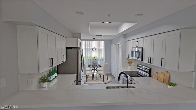 kitchen featuring white cabinets, light stone countertops, sink, and appliances with stainless steel finishes