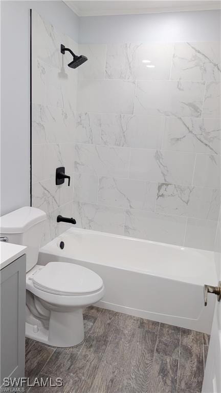 full bathroom featuring toilet, vanity, and tiled shower / bath