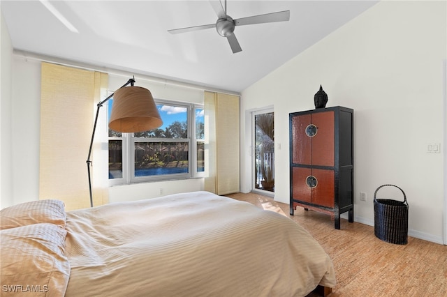 bedroom with ceiling fan, light hardwood / wood-style floors, and vaulted ceiling