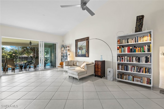 sitting room featuring built in shelves, ceiling fan, light tile patterned floors, and lofted ceiling