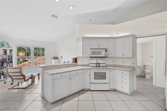 kitchen featuring white cabinetry, kitchen peninsula, lofted ceiling, white appliances, and light tile patterned floors