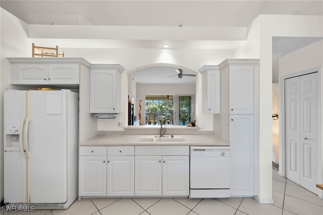 kitchen with white cabinetry, sink, ceiling fan, white appliances, and light tile patterned floors