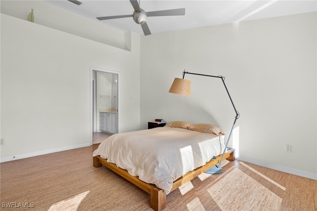 bedroom with carpet, connected bathroom, and ceiling fan