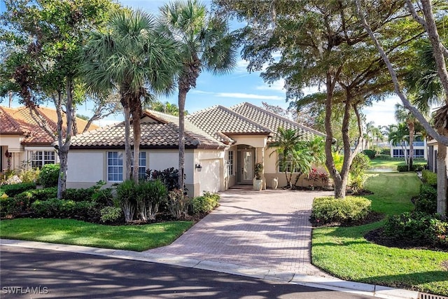 mediterranean / spanish home featuring a front yard