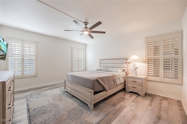 bedroom with ceiling fan and light hardwood / wood-style flooring