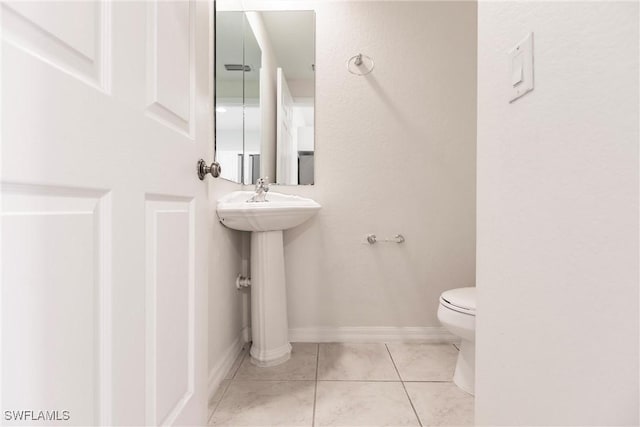 bathroom featuring tile patterned floors and toilet