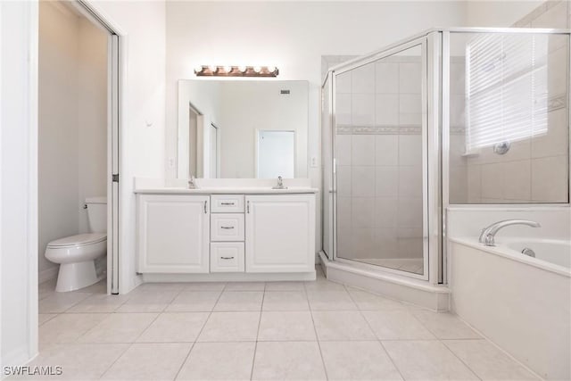 full bathroom with tile patterned flooring, vanity, separate shower and tub, and toilet