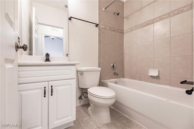 full bathroom featuring tile patterned floors, vanity, toilet, and tiled shower / bath