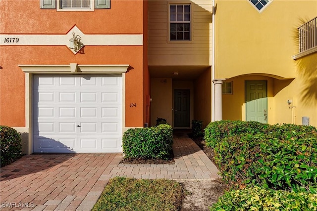 view of exterior entry featuring a garage