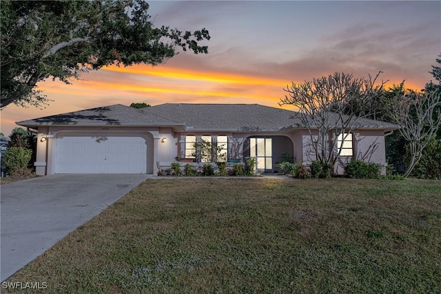 view of front of home with a lawn and a garage