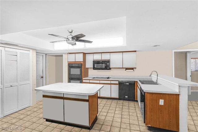 kitchen with a kitchen island, ceiling fan, sink, black appliances, and white cabinetry