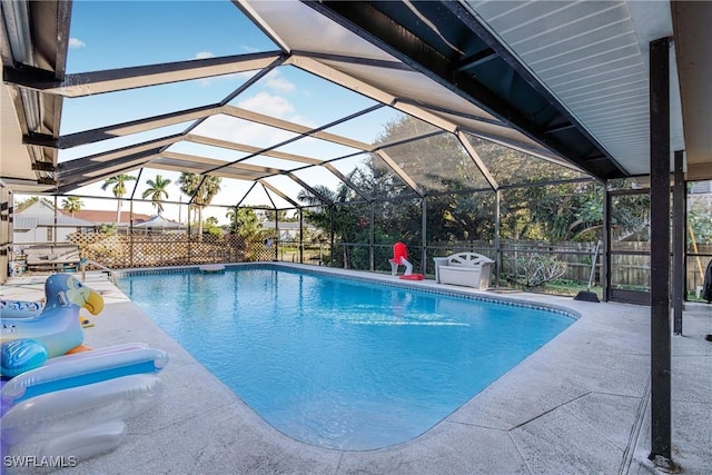 view of pool with a patio area and a lanai