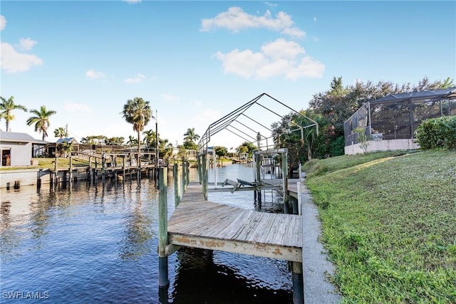 view of dock with a lawn, a lanai, and a water view