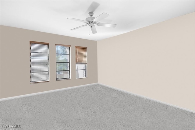 unfurnished room with carpet flooring and ceiling fan