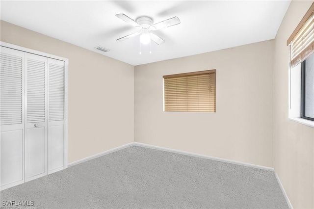 unfurnished bedroom featuring ceiling fan, a closet, and carpet