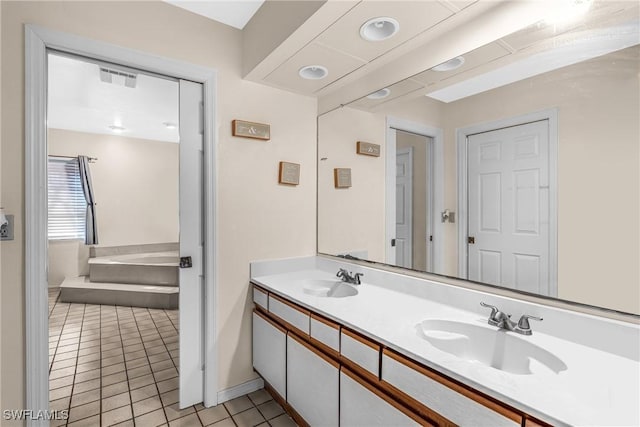 bathroom featuring a bath, vanity, and tile patterned floors