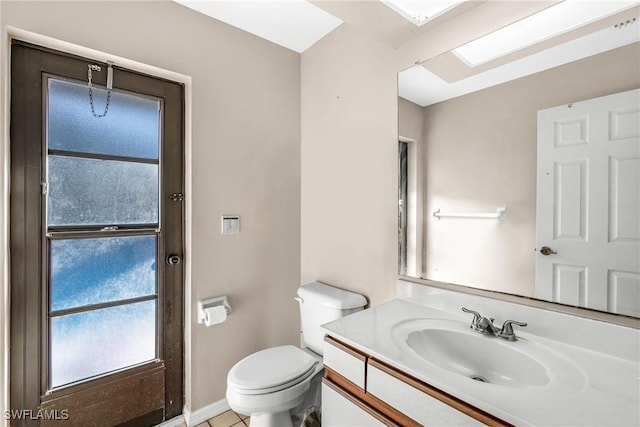 bathroom featuring tile patterned floors, vanity, and toilet