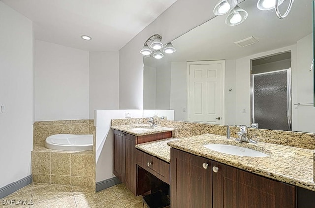 bathroom featuring tile patterned floors, vanity, and shower with separate bathtub