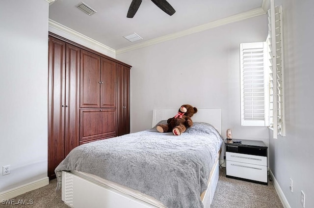 carpeted bedroom featuring ceiling fan and crown molding