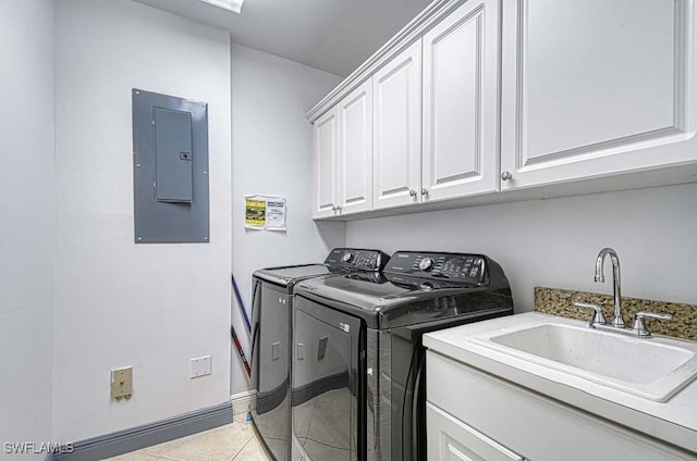 clothes washing area with sink, cabinets, washing machine and dryer, electric panel, and light tile patterned floors