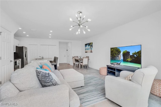 living room featuring a notable chandelier and sink